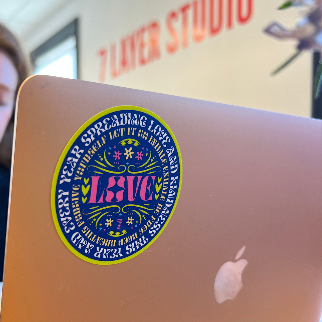 circular Love sticker on laptop