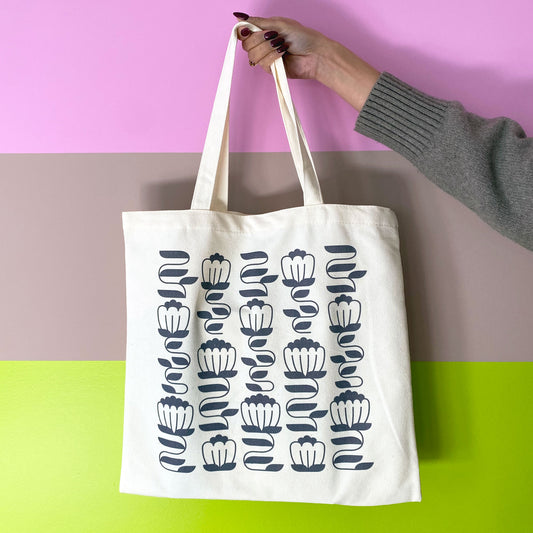 floral tote held in front of striped wall